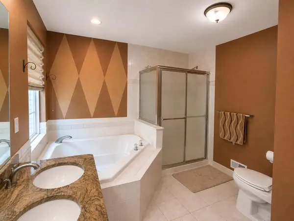 Primary bath with jacuzzi-type tub and stall shower