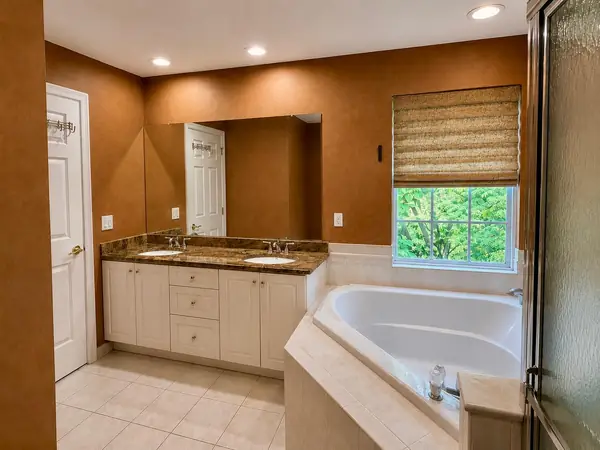 Primary bath double vanity with corner soaking tub
