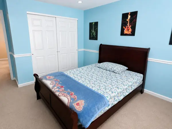 Bedroom with double closet and dark wood bed