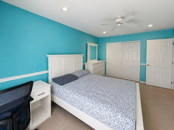 Third bedroom with ceiling fan and closet