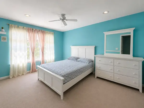 Bedroom with white furniture and dresser