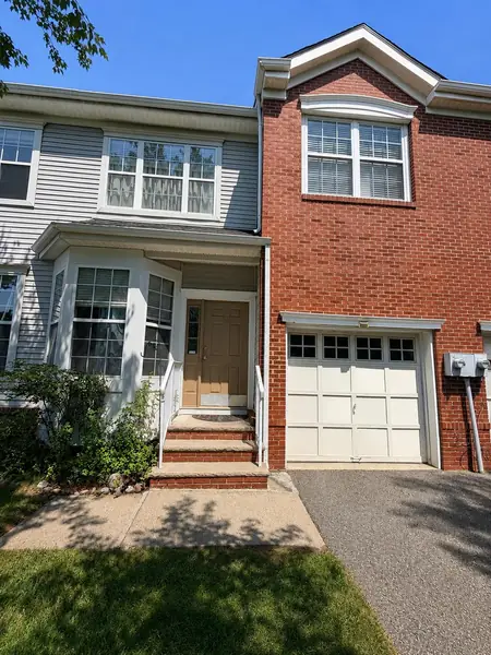Front exterior with brick facade and attached garage