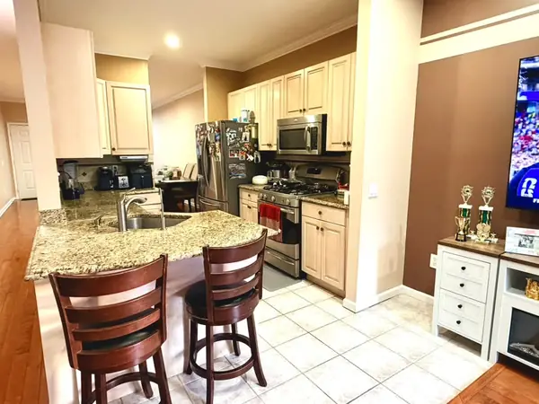Kitchen with granite breakfast bar and Italian tile flooring