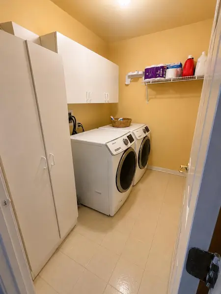 Second-floor laundry room with washer and dryer